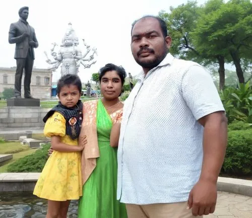 a family poses for a po in front of the statue,lalbagh,mayapur,gannavaram,agartala,sarnath,thirupathi