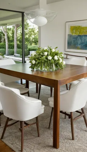 White leather chairs by Lee Industries flank the kitchen table, which can expand to accommodate 14.,dining room table,dining table,kitchen & dining room table,dining room,conference table,californian 