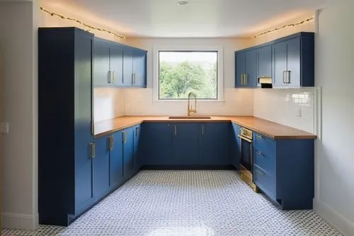 A bright, cozy kitchen featuring a large farmhouse sink beneath three large windows, flooding the space with natural light. The lower cabinets and drawers are painted in a deep navy blue, accented by 