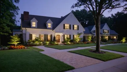 American house, suburban residence, modern architecture, sloping roof, white walls, wooden doors, large windows, green lawn, garden, flower beds, tall trees, brick pavement, sidewalk, mailbox, streetl