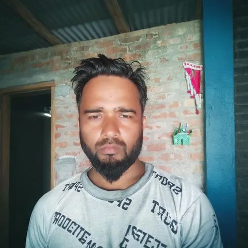 a man wearing a gray shirt and beard stares at the camera,rautahat,bikash,nazmul,pokhrel,baghel,biswajit,farkhar,satpal,sabbaruddin,shahnawaz,rohit,dheeraj,shikhar,partap,budaun,chettri,amarjit,samarj