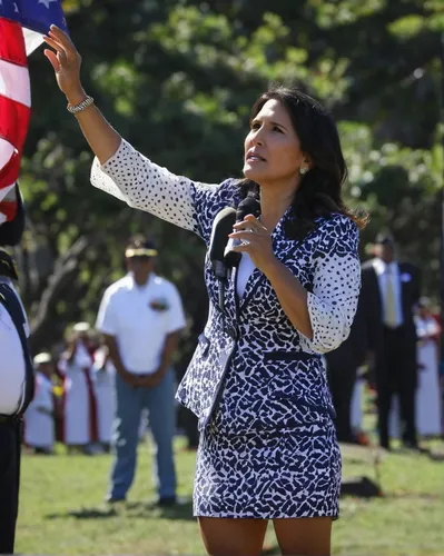 Congresswoman Tulsi Gabbard salutes during the singing of the National Anthem during promotion ceremonies at the National Memorial of the Pacific. Punchbowl Cemetery. 12 oct 2015. photograph by Cory L