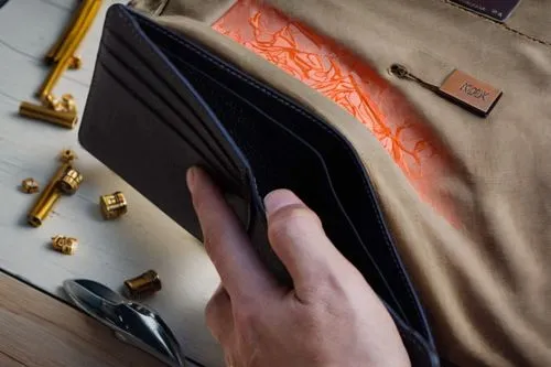 an open wallet is on top of a bag,clipboard,clipboards,garrisoning,leatherwork,gunsmithing,kapton