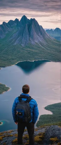 Man with a backpak looking at Segla in Senja,yukon territory,baffin island,fjäll,greenland,trolltunga,northern norway,backpacking,norway,nature and man,mountain guide,blue hour,scandinavia,nordland,no