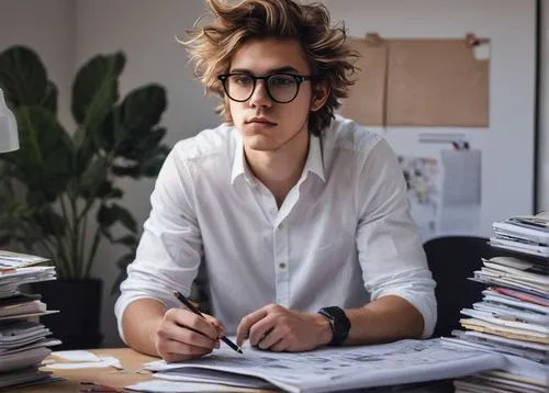 Architecture student, male, 20yo, messy hair, black framed glasses, casual wear, jeans, white shirt, sneakers, holding a large portfolio, sitting at a desk, surrounded by design papers, pencils, erase