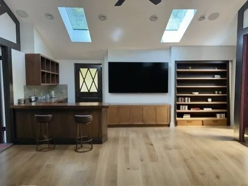 dark cabinetry,cabinetry,entertainment center,dark cabinets,wood flooring,under-cabinet lighting,hardwood floors,cabinets,walk-in closet,laminate flooring,game room,bonus room,tv cabinet,modern room,modern kitchen interior,flooring,smart home,kitchen cabinet,hallway space,family room