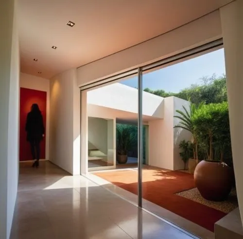 PEOPLE,an open door into a large room with a red plant,interior modern design,home interior,contemporary decor,champalimaud,mahdavi,breezeway