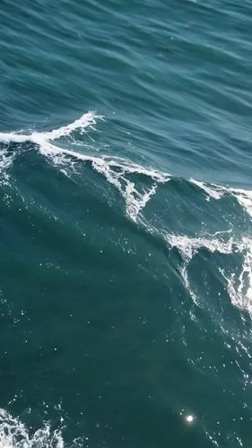 a wave crashes over an ocean surface, and another person surfing the water,ocean waves,braking waves,wave pattern,water waves,waves circles,japanese waves