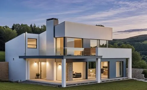 A modern, minimalist white house with clean lines and a few stone accents on the façade. The porch features white beams, complementing the sleek, minimalist design. The house is slightly elevated abov