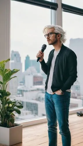 Modern living room, YouTube creator, 30s, male, stylish hair, glasses, casual wear, holding microphone, standing, indoor plants, wooden floor, minimalist decor, white walls, large window, natural ligh