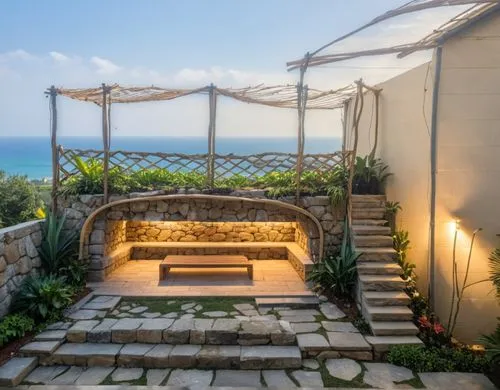 Cozy, backyard grotto, stone arched entrance to grotto, stone back wall, u-shaped seating inside grotto,  tropical plants and bushes, wood deck above the grotto with seating, paved circular centerpiec