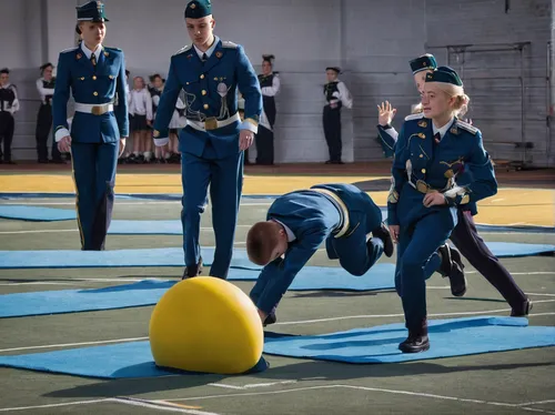 Write a lighthearted scene where cadets engage in a friendly competition to test their skills and teamwork.,color guard (flag spinning),ball (rhythmic gymnastics),polish police,goalball,navy burial,bo