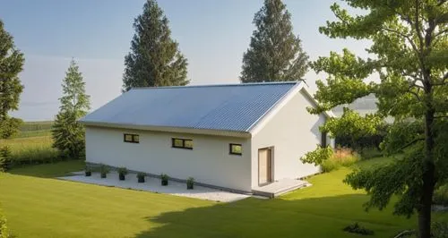 small modern house surrounded by a garden.
The walls are white. Gray roof.,a house with a sloping roof near a forest,passivhaus,danish house,farm house,field barn,farmhouse,inverted cottage,Photograph