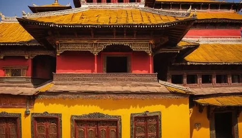 Nepalese architecture, traditional pagoda-style temple, intricately carved wooden doors, ornate golden roof, vibrant red and yellow walls, delicate stone carvings, intricate stonework, ornate windows,