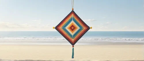 Craft a serene Ojo de Dios hanging by a sun-kissed beach.,wind chime,wind chimes,beach umbrella,sport kite,nautical bunting,pennant garland,wind bell,fish wind sock,beach furniture,hanging decoration,