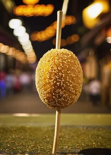 Traditional Chinese dessert, xucha, sweet potato, golden brown, crispy outer layer, soft fluffy inner filling, sesame seeds, wooden stick, night market, Taipei, street food, warm lighting, shallow dep