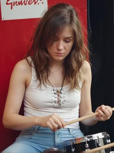 A great female drummer.,a woman sitting down playing on a drum,bongos,drumming,street musician,musician,woman playing,busking,Photography,Documentary Photography,Documentary Photography 15