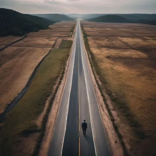 a man in front of a road that increasingly divides into more and more roads,long road,open road,road to nowhere,alcan highway,the road,empty road,saskatchewan,mavic 2,highway,road of the impossible,ro