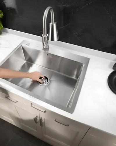 a close up of a person fixing a sink in a kitchen,mixer tap,kitchen sink,sink,stone sink,sinkler,rohl