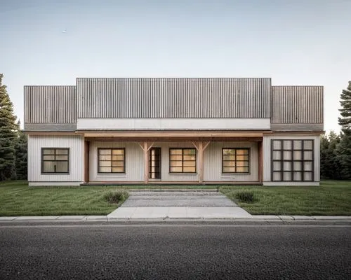 Show that there are trees behind and a road in front of the house. There are chairs inside the, road in front of the houses.house. Grass, realistic photo, USA. There is a road ahead. An evening. ,mode