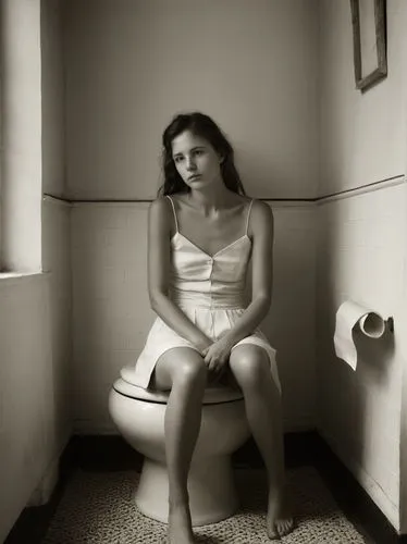 Sitting woman,a woman in a white dress sitting on top of a toilet,depressed woman,premenstrual,female alcoholism,pmdd,anorexia,bulimia,Photography,Black and white photography,Black and White Photograp