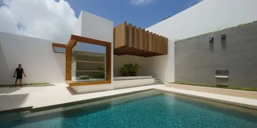 DISEÑO DE UNA PALAPA  ESTILO MINIMALISTA, CON PERGOLAS DE CONCRETO, ELEMENTOS PARA SOMBRE, LOSA DE CONCRETO CON CANAL DE ACERO, CANCELES DE ALUMINIO CON CRISTAL, MURO CASCADA CON ESPEJO DE AGUA,a man 