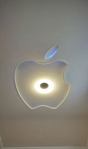 Gypsum decoration in the ceiling of a room with hidden LED lighting,a ceiling with an apple logo on it,ceiling light,ceiling lamp,isight,apple logo,wall lamp,apple desk,Photography,General,Realistic