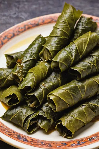 Write a recipe for stuffed grape leaves with a Mediterranean twist.,vine leaves,wild grape leaves,grape leaves,curry leaves,laulau,zongzi,north vietnamese spring rolls,callaloo,laotian cuisine,spinach