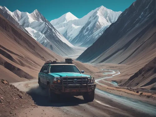 Journey through the rugged landscapes of the Pamir Highway,the pamir highway,the pamir mountains,himalaya,himalayas,tata safari,everest region,himalayan,karakoram,steep mountain pass,jeep wagoneer,mou