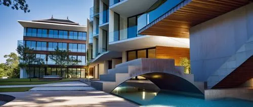 a building with a bridge going to a water feature,seidler,modern architecture,modern house,landscape design sydney,corten steel,landscape designers sydney,dunes house,cubic house,contemporary,cube hou