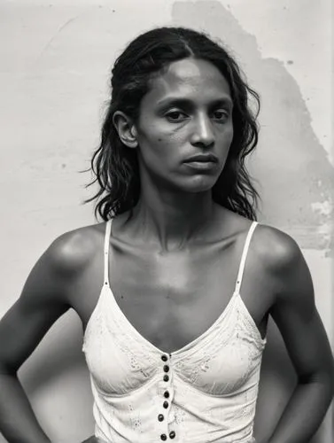 Black and white quality photograph of a dancer; very unkempt. The background is blurred.,a woman poses in a black and white po,hijras,buakaw,indian woman,thandie,mccoughtry,nalini,Photography,Black an