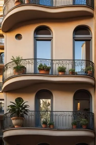 Modern Barcelona architecture, sleek lines, curved shapes, Gaudí-inspired details, ironwork balconies, ceramic tiles, grand staircase, high ceilings, large windows, natural light pouring in, minimalis