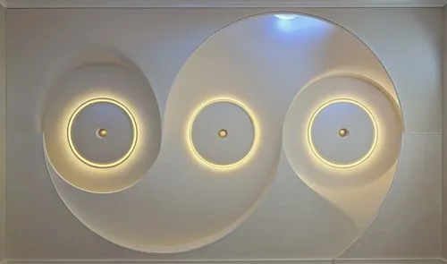 Gypsum decoration in the ceiling of a room with hidden LED lighting,a wall is made with an assortment of circular and round lights,wall light,wall lamp,ceiling light,eero,foscarini,ceiling lamp,Photog