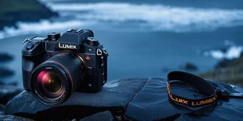 a lumix camera social media poster design in a dark place,a camera and flash unit sitting on rocks next to the ocean,slr camera,nikon,lumix,technikon,lensman,canon 5d mark ii,Photography,General,Reali