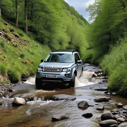 A gray Land Rover Freelander 4 wheel car is traveling on an off-road route. There is a stream blocking the car's running path.,land rover freelander,land rover discovery,tata safari,range rover,nissan