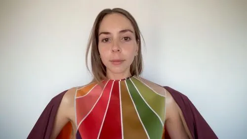 a woman standing with a colorful piece of art covering her neck,colorama,eurythmy,color fan,solfeggio,chakras,hexahedron