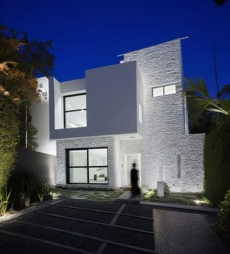 Diseño exterior de una casa moderna estilo minimalista combinando muros de color blanco con muros de tabique aparente, herrería de aluminio con cristal, fotografía hiperrealista, fotografía arquitectó