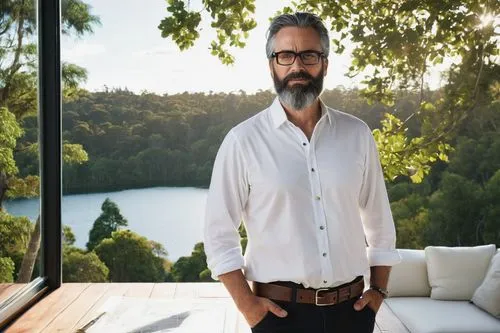 Mature male architect, designer, Taupo style, standing, hands on hips, wearing black framed glasses, short dark hair, beard, white shirt, rolled up sleeves, dark jeans, brown leather belt, black boots