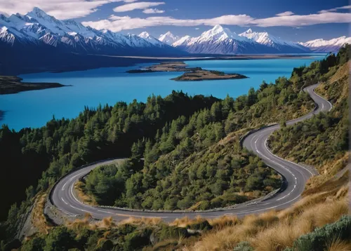 A road snakes it way down to Lake Pukaki with snowcapped mountains in the distance.,new zealand,south island,nz,mt cook,newzealand nzd,winding roads,carretera austral,tekapo,mountain highway,north isl