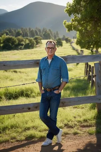 Middle-aged man, Tom Hanks style, casual dude, relaxed facial expression, slight smile, messy brown hair, glasses, denim shirt, blue jeans, sneakers, hands in pockets, leaning against a wooden fence, 