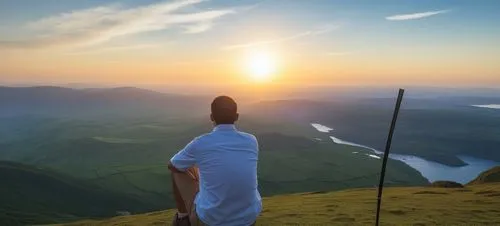 a man sitting on top of a grass covered hill,mountain sunrise,paraglider sunset,above the clouds,nature and man,the spirit of the mountains,senja,Photography,General,Realistic