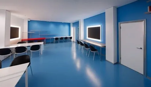 maker space, robotics , workspace , lego, keep colors as picture ,a blue floored room with white walls and black chairs,examination room,doctor's room,treatment room,hospital ward,therapy room,cleanro