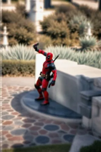 "In the image, Deadpool stands in front of a distant statue, taking a selfie with his phone and looking at the phone.",cliffjumper,vanterpool,kuuga,takanuva,dead pool,bionicle,deadpool,vakama,mebius,m