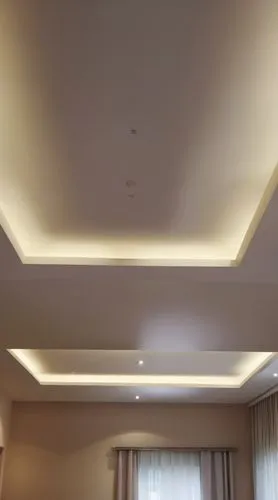 Gypsum decoration in the ceiling of a room with hidden LED lighting
Decor out of the ceiling,a white ceiling is lit up in a room,stucco ceiling,ceiling lighting,ceiling light,ceiling construction,plaf