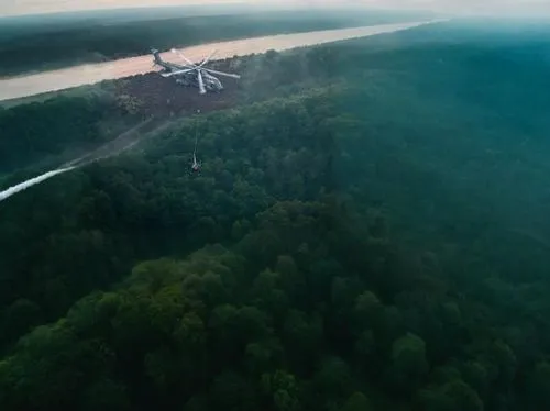 a view from an airplane looking down at several vehicles that are flying above trees,malopolska breakthrough vistula,sunrise flight,from the air,the pictures of the drone,kamov,bialowieza,aerial lands