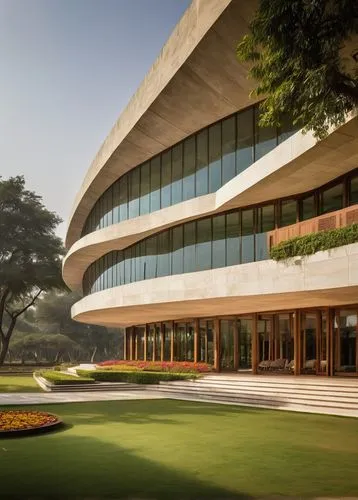 Indian Council of Architecture, modern building, New Delhi, India, sleek glass façade, angular lines, grand entrance, sprawling lawn, tropical trees, vibrant flowers, warm sunlight, dramatic shadows, 