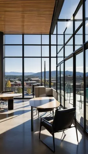 Modern Spokane architecture firm, sleek glass building, angular lines, steel frames, urban landscape, cityscape, downtown area, afternoon sunlight, soft shadows, detailed textures, reflective windows,