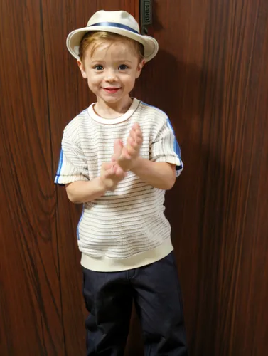 Wearing a small hat, in the background of a river and beautiful vegetation,stetson,boys fashion,panama hat,baby & toddler clothing,trilby,boy model,boy's hats,grandson,boy praying,a wax dummy,cricket 