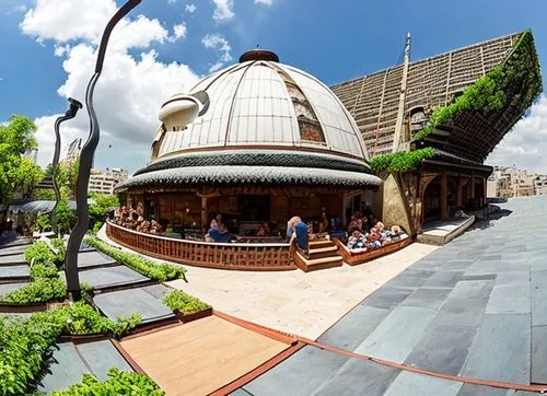 The open-air scene, characterized by different elements that combine in a suggestive way. At the center of it all stands a majestic domed-roofed restaurant. next to the house there is a market which h