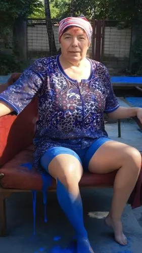 a woman sitting on top of a bench covered in blue substance,thighpaulsandra,rigoberta,arino,kazakhs,sportacus,khudoberdyev,granma,dadong,rikishi,hijras,maradona,gaki,uzbeki,chonbuk,manang,szewczenko,k